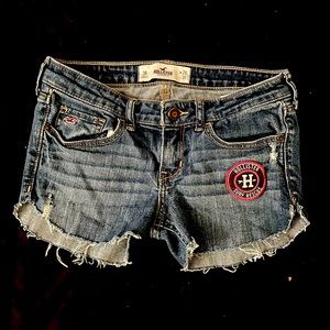 Distressed hollister patched dark denim shorts